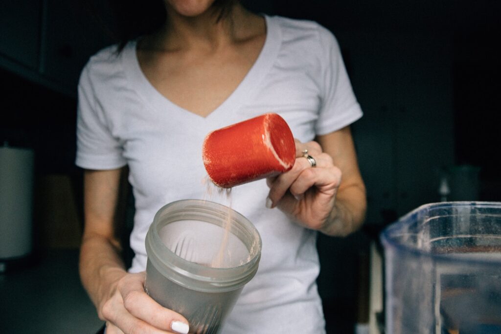 Morning Routine: Pouring protein shake powder into a cup